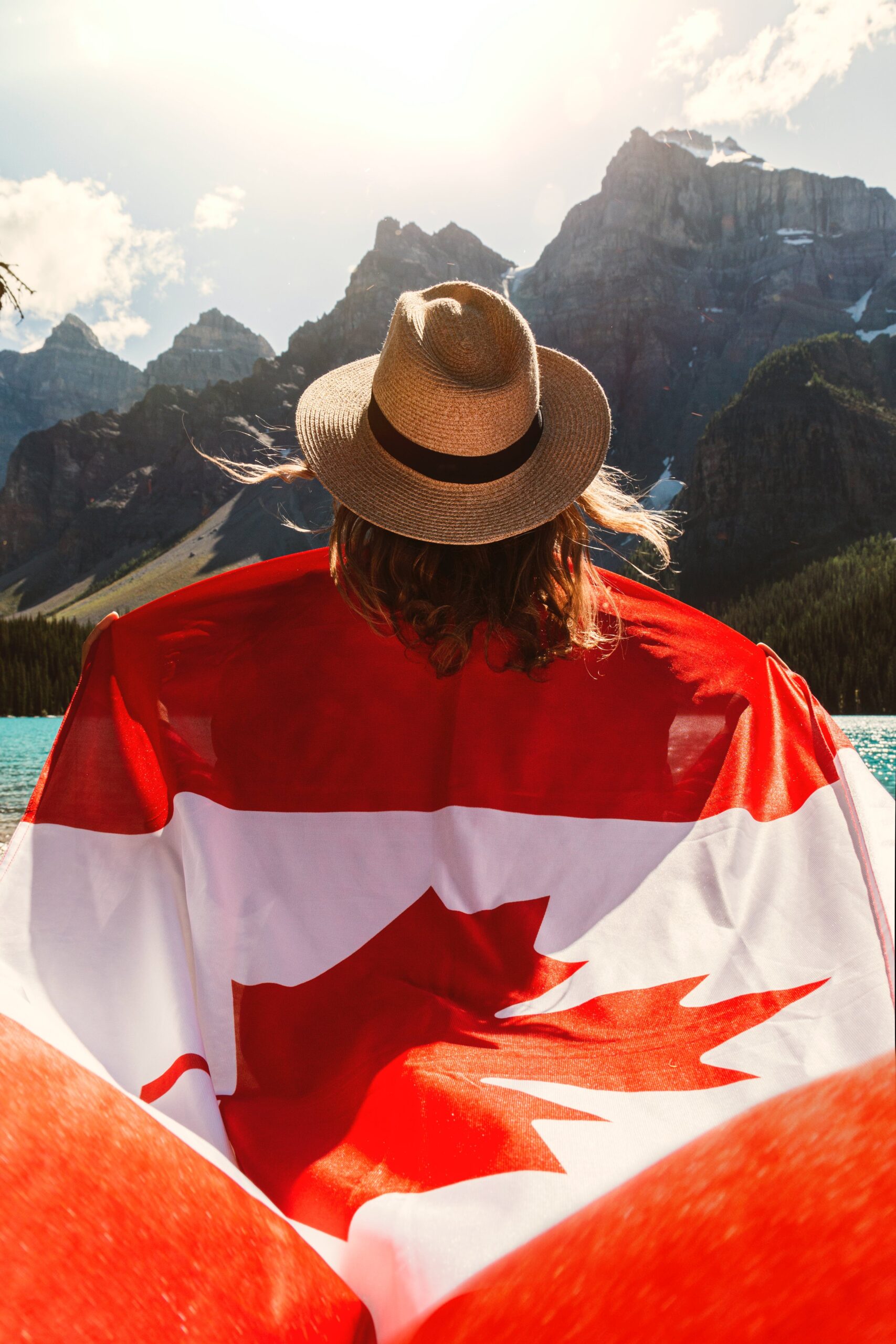woman holding canada flag in the mountains